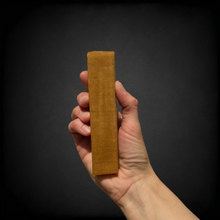 A photo of a hand holding a medium yak chew