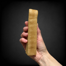 A photo of a hand holding an xl yak chew 